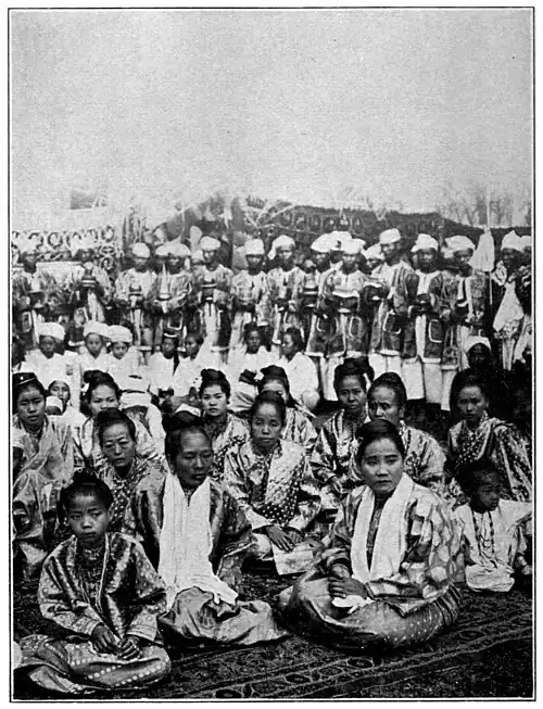 BURMESE LADIES AT A GARDEN PARTY.